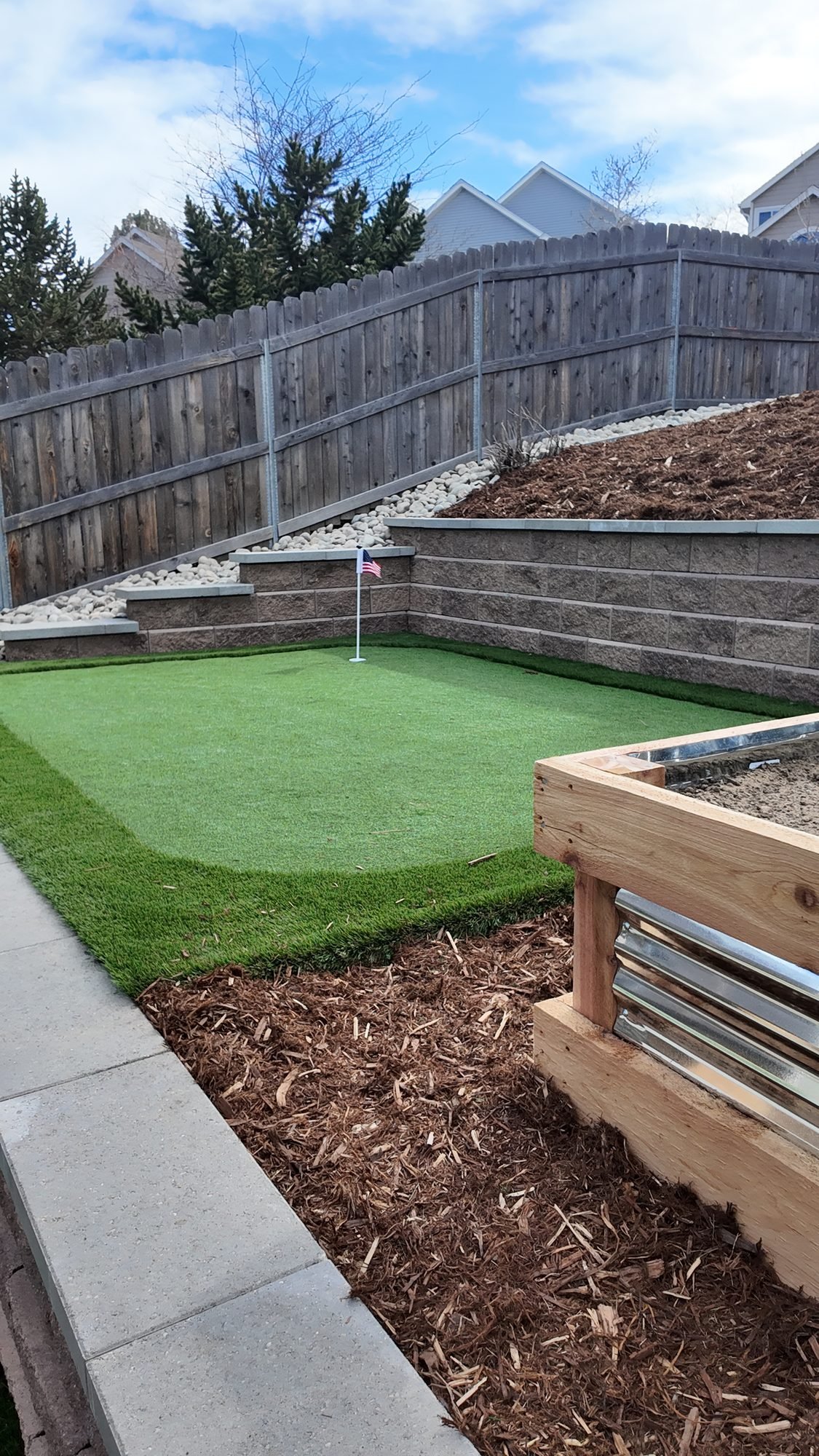 Aerial view of backyard putting green and paver walkway, Colorado