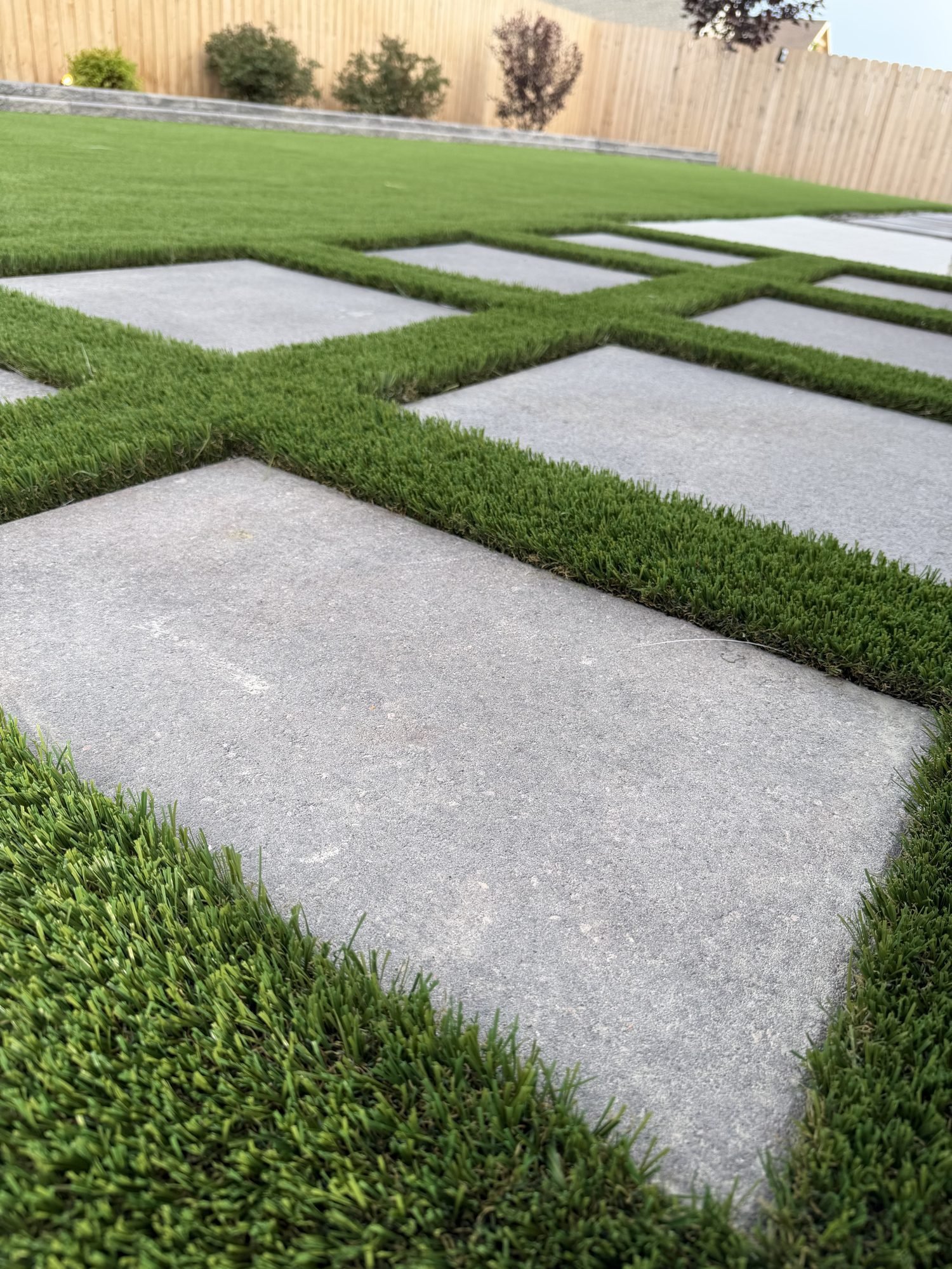 Geometric concrete paver and artificial turf patio design, Colorado hardscaping