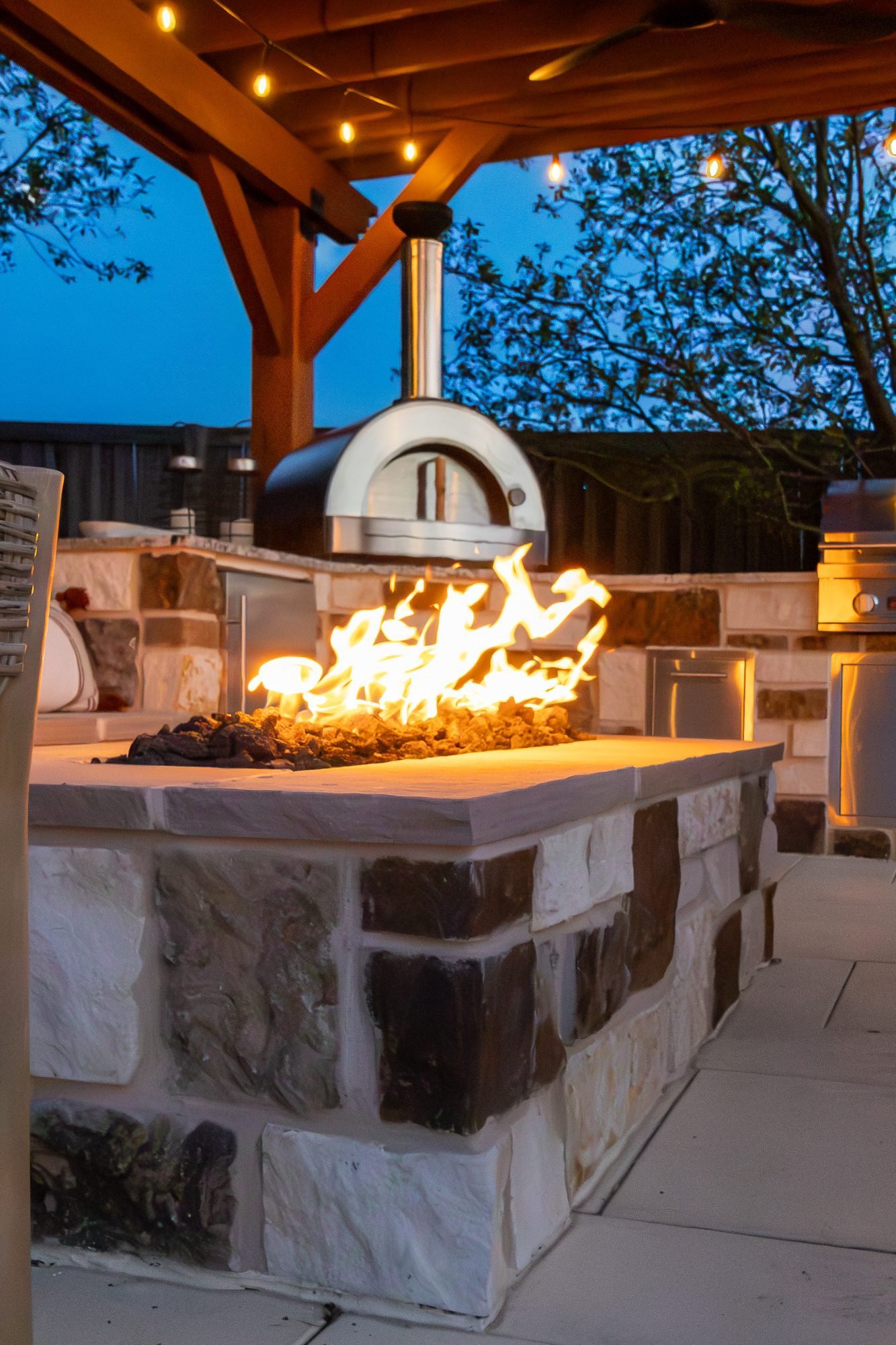 Outdoor kitchen and pool hardscape by ORO Landscape, Colorado